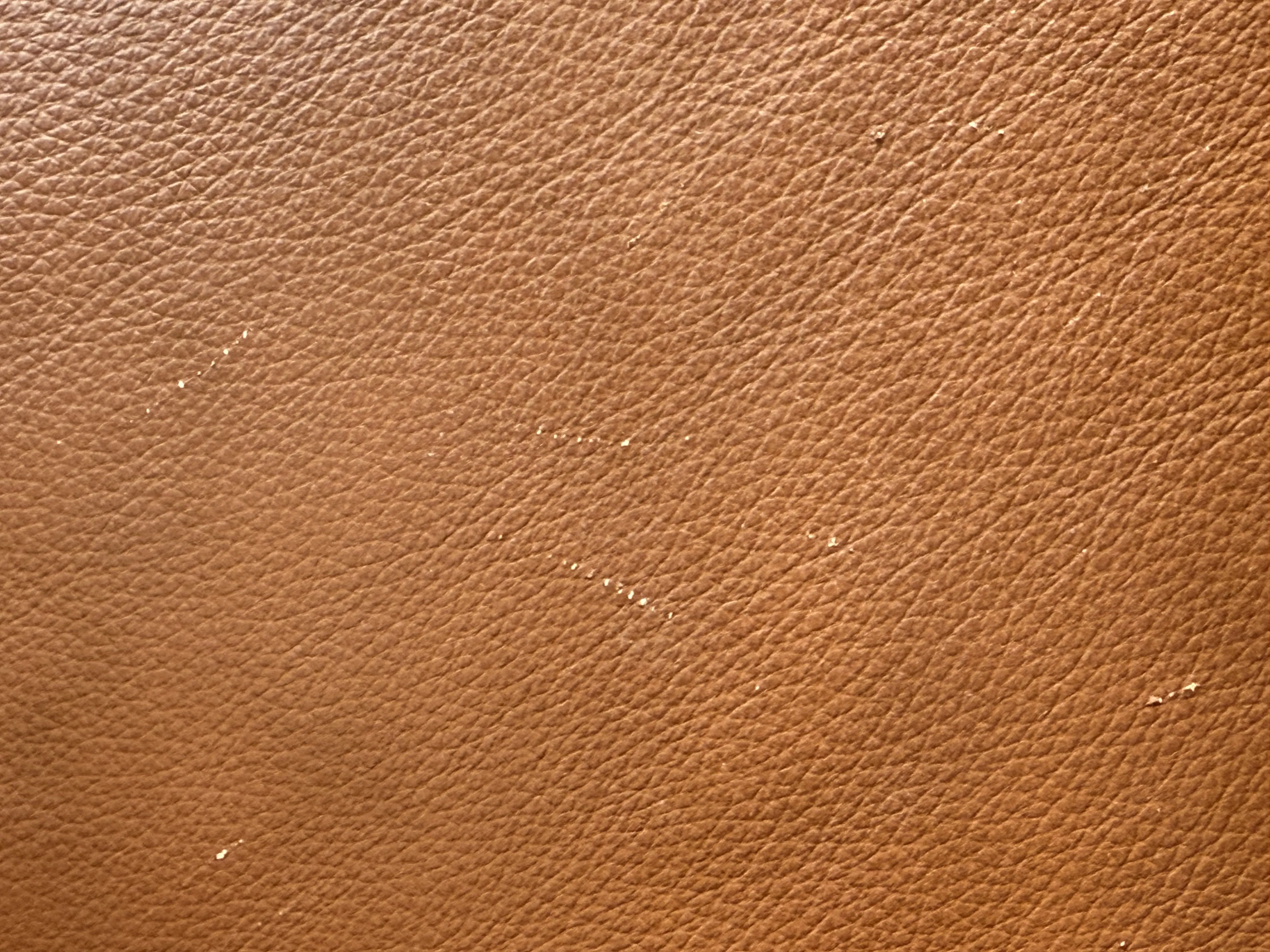 Photo of scratches in a brown faux leather chair